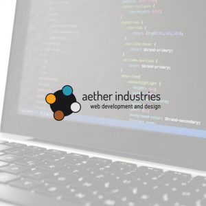 Aether Industries logo overlaid on a photo of a laptop computer displaying CSS code